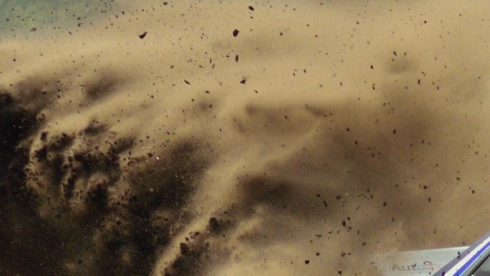 Rally car 705 Eric van Loon coming around the curve large cloud of dust kicked up behind him grid tile 1