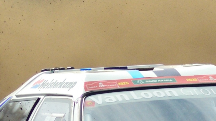 Rally car 705 Eric van Loon coming around the curve large cloud of dust kicked up behind him grid tile 2