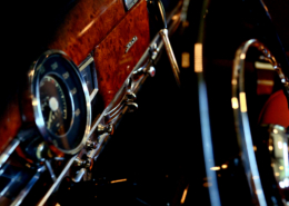 Mustang 300 behind the steering wheel dash with gorgeous red wood combined with chrome dials, buttons and air vents.